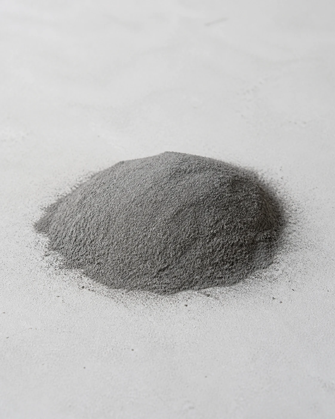 Fine gray High-Performance Fly Ash powder on a pale concrete surface.