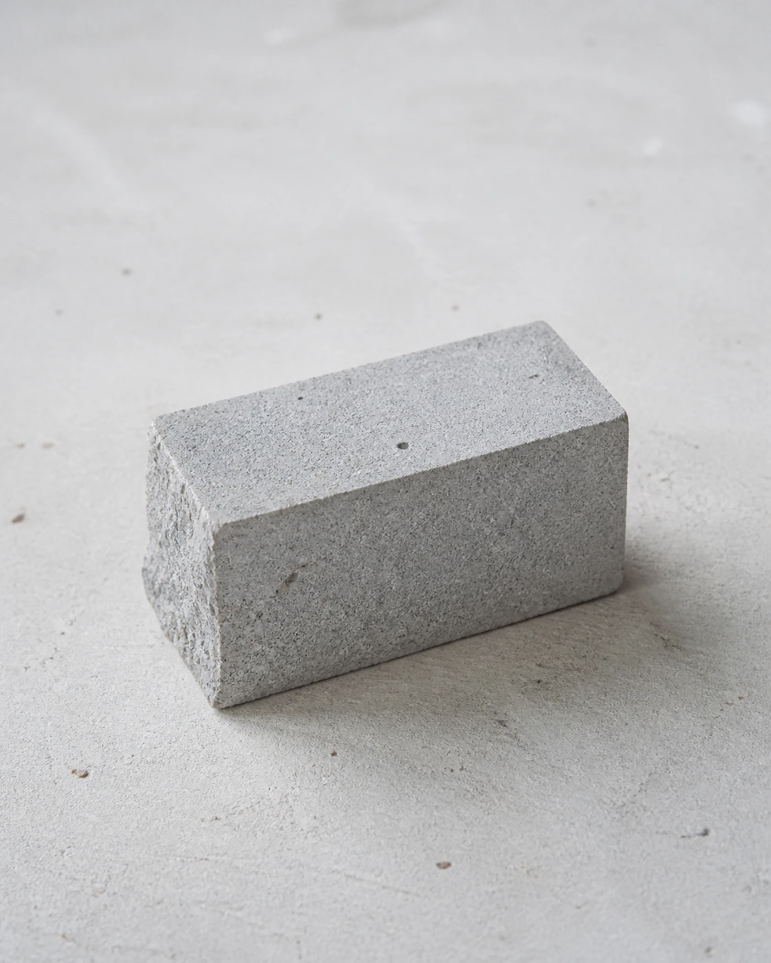 Concrete specimen representing VerdantRock Technology's High-Performance Mineral Admixture on a pale mineral surface.
